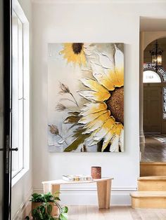 a large sunflower painting hanging on the wall