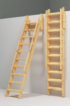 two wooden ladders are next to each other