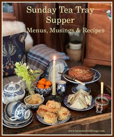 a table topped with plates and bowls filled with food next to a candle on top of a wooden table