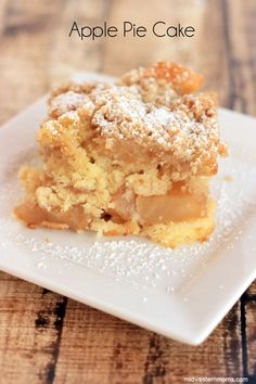 a piece of cake sitting on top of a white plate with powdered sugar on it