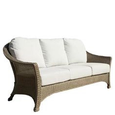 a wicker couch with white pillows on it's back and seat cushiones