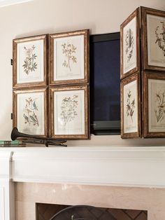 a living room with a fire place and pictures on the mantle