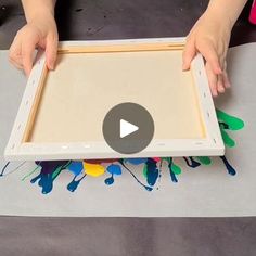 a person is holding an open box with paint on it