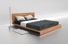 a bed sitting on top of a white floor next to a wooden headboard and foot board