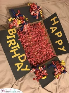 a birthday card made out of shredded red and yellow paper with the words happy birthday written on it