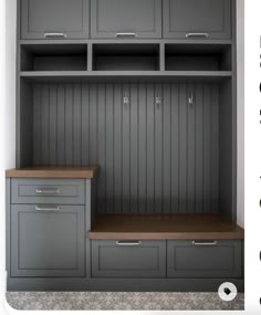 an empty room with gray cabinets and drawers