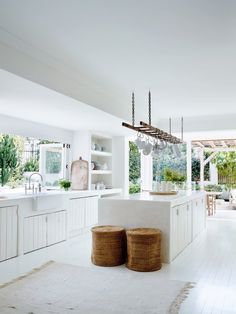 an image of a kitchen with white walls and flooring in the same color scheme