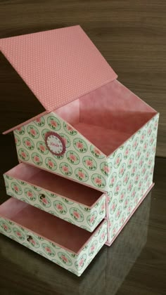 an open pink and green box sitting on top of a table