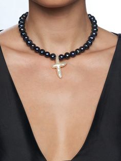 Large Black Freshwater Pearls Freshwater Pearl Cross Pendant Stainless Steel Clasp Length: 15 or 18 Inches + Extension Chain 15 Inch Size Pictured Handmade in Los Angeles - please allow 1-5 business days for this item to ship THE BLACK PEARL GEMMA CROSS CHOKER features stunning iridescent black pearls, punctuated with a large white freshwater pearl cross pendant. This one-of-a-kind piece will elevate all your looks. Wear it to update a simple tee look or to complete a night fit! The Black Pearl, Iridescent Black, Black Freshwater Pearls, Cross Choker, Black Pearls, Simple Tee, Simple Tees, White Freshwater Pearl, Black Pearl