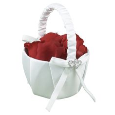 a white basket with red roses in it