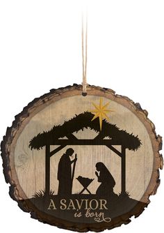 a wooden ornament with a nativity scene on it