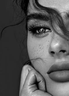 black and white photograph of a woman with freckles on her face looking at the camera