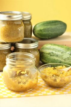 jars filled with food sitting on top of a yellow and white checkered table cloth