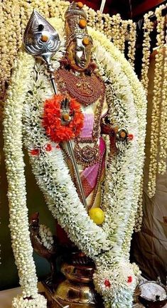 the statue is decorated with flowers and other decorations