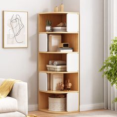 a living room with a white couch and a wooden shelving unit in the corner