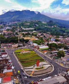 an aerial view of a city with mountains in the background