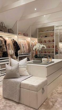 a large closet filled with lots of shoes and handbags on top of white shelves