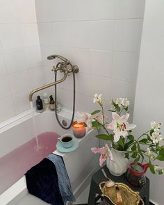 a bathtub with flowers and candles in it