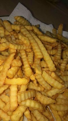 a pile of french fries sitting on top of a table