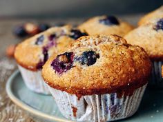 several blueberry muffins on a plate ready to be eaten