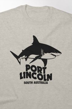 a gray t - shirt with the words port lincoln and a shark in black on it