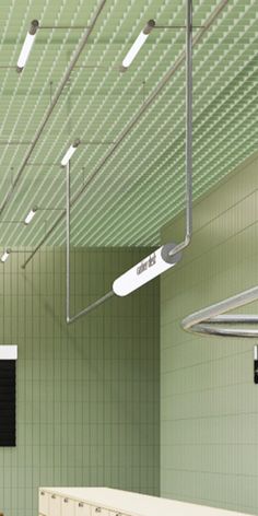 an empty bathroom with green walls and white fixtures on the ceiling is pictured in this image