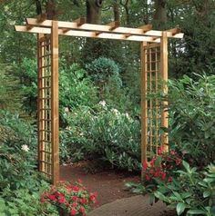 a wooden arbor in the middle of a garden