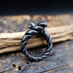 Black, twisted iron ring perfect gift for a man, boyfriend or husband. Made using traditional blacksmithing techniques of fire, hammer and anvil.  Surface texture is achieved through different shaped hammers and hand held chisels and profiling tools. The ring sealed with a clear wax for protection. US size- 10 1/2 Width - up to 7mm This original handiwork can become a exclusive, nice piece of your style. Presented in a gift bag.  European & International orders are sent by Standard post with tra Modern Hand Forged Rings As Gift, Hand Forged Black Rings For Anniversary, Classic Hand Forged Rings For Gift, Hand Forged Rings As Gift, Rustic Hand Forged Promise Ring, Hand Forged Spiral Ring For Gift, Hand Forged Spiral Ring As Gift, Hand Forged Spiral Rings For Gifts, Artisan Black Hand Cast Jewelry