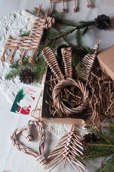 some christmas decorations are laying out on a doily next to pine cones and twine