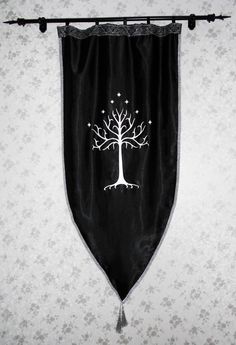 a black and white wall hanging with a tree on it