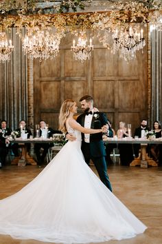 a bride and groom dance together at their wedding reception in an old - fashioned ballroom