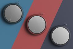 three round mirrors sitting next to each other on top of a blue and red wall