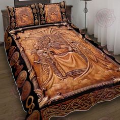 a bed covered in an intricately designed comforter and pillow case with the image of jesus on it