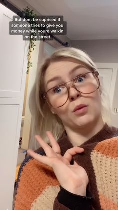 a woman wearing glasses making the vulcan sign with her hand and saying, but don't be surprised if she sees someone who makes money while you walk on the street