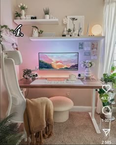 a desk with a computer on it and some plants in the corner next to it