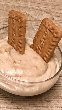 two crackers sticking out of a bowl of dip