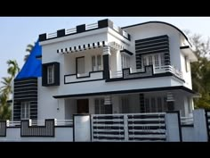 a white and black house with blue roof