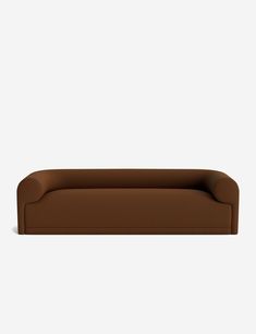 a brown couch sitting on top of a white wall