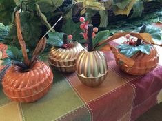 three decorative pumpkins sitting on top of a table