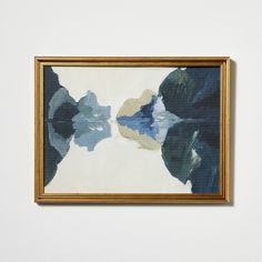 a painting hanging on the wall in front of a white wall with a gold frame