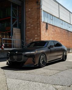 a car parked in front of a brick building