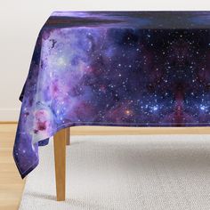 a table with a purple and blue galaxy design on it