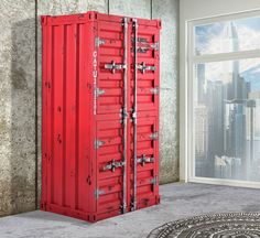 a red double doored room divider stands in front of a large cityscape