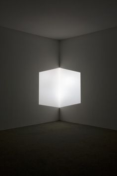 an empty room with a square light in the middle