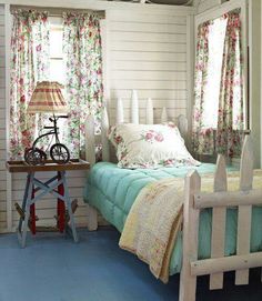 a bed room with a neatly made bed and a bicycle on the table next to it