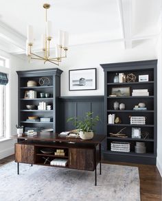 a living room filled with lots of furniture and bookshelves