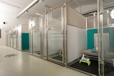 an empty room with glass partitions on the walls