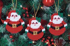 three christmas ornaments hanging from a tree