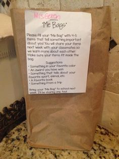 a brown paper bag sitting on top of a counter next to a sign that says me bag