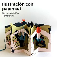 an open book with paper cutting on it